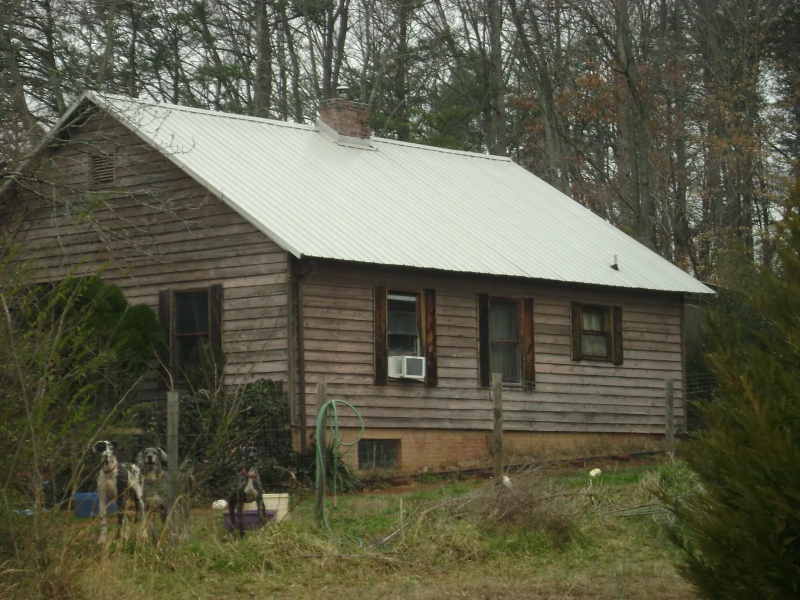 White metal roof on an old wood sided farmhouse, from a Metal Roof Installation job in Bennington